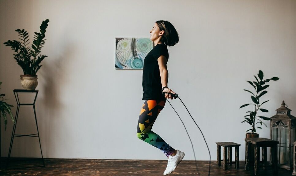 a girl doing an exercise with a jump rope